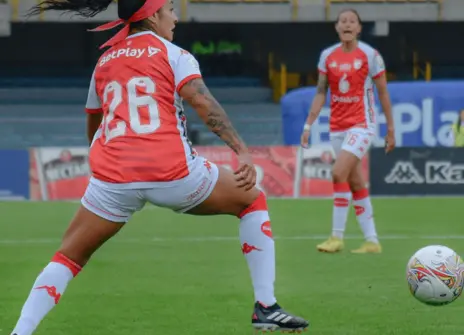 Two women playing football.