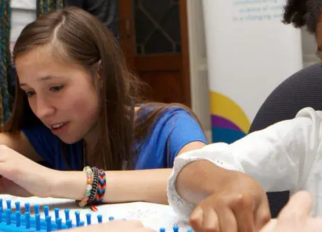Volunteer and young participant getting stuck in at an Ri Family Fun Day