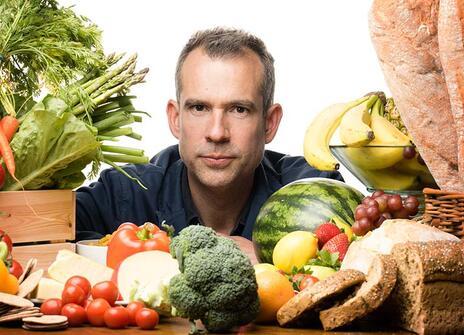 chris is surrounded by food items