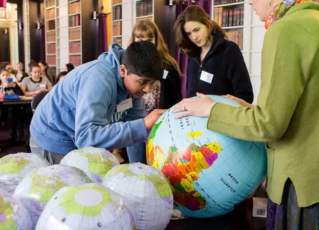 Students interacting with an inflatable globe during a maths Masterclass in the Ri's Conversation Room