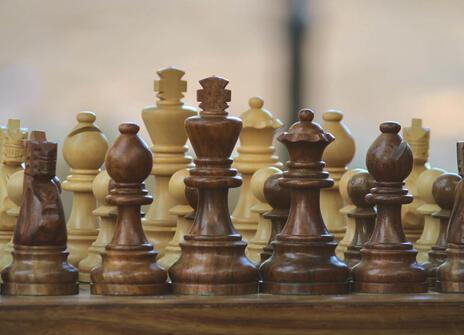 chess board with chess pieces made out of wood