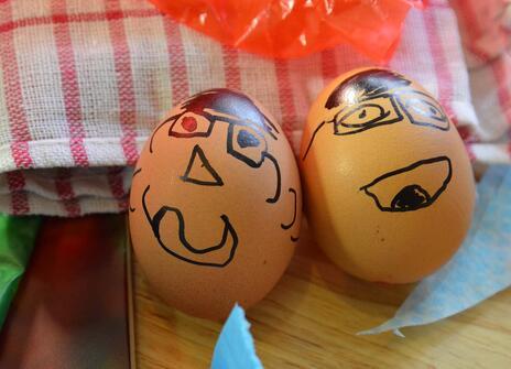 two eggs with faces drawn on them