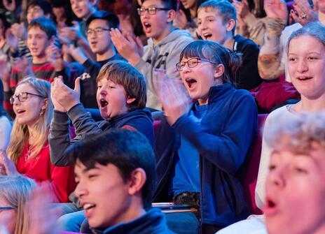 Christmas Lectures audience whooping and clapping at something off camera