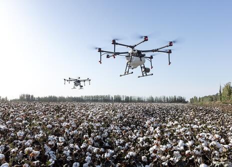 Image of drones hovering over a field