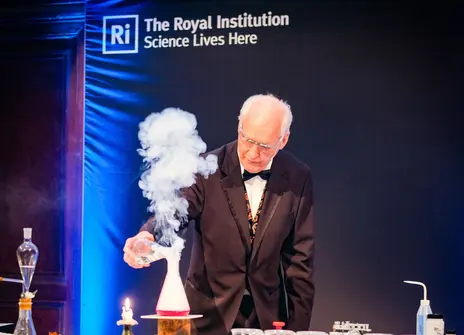 Image of Andrew at the Ri with a plume of smoke coming out of a conical flask in front of him