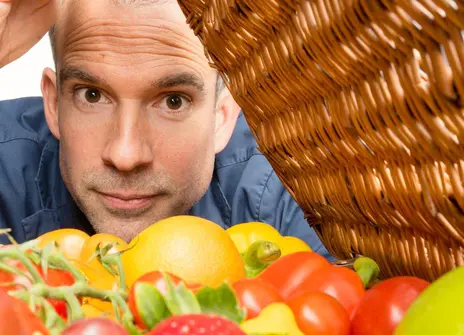 Chris van Tulleken looking inside a food rattan basket