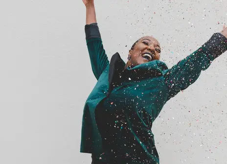 Woman celebrates as confetti falls