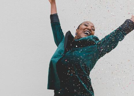 Woman celebrates as confetti falls