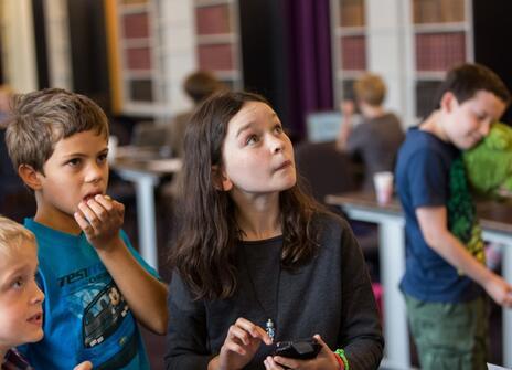 Students stunned looking at a science demonstration