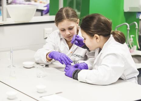 Two students experimenting with pH paper