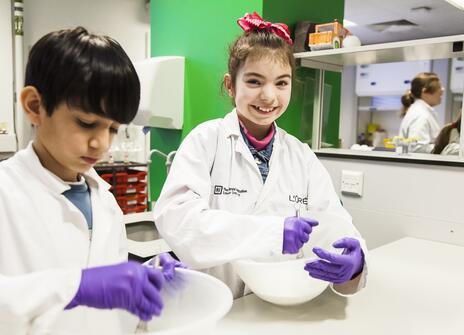 Two students with mixing bowls