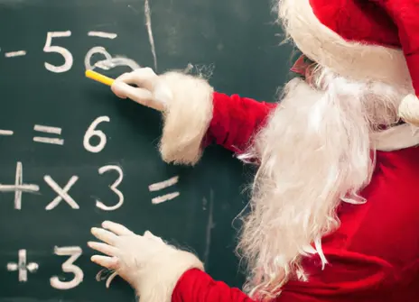 Santa writing maths on a chalkboard