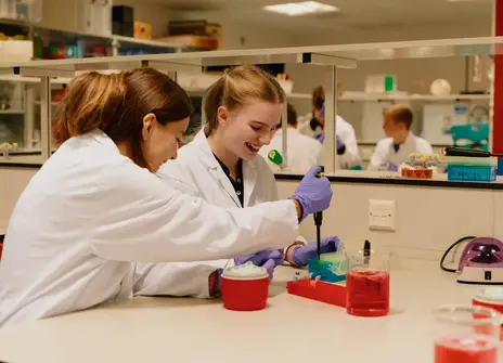 Two students using a micropipette 