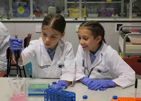 Two students using a micropipette 