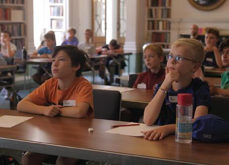Image of young children sat at a desk