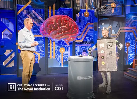 Mike the christmas lecturer is standing alongside our colleague Mike dressed as a robot
