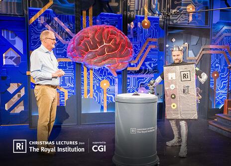 Mike the christmas lecturer is standing alongside our colleague Mike dressed as a robot