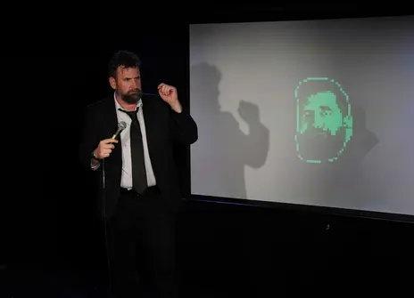 Garrett Millerick with his AI clone on a screen