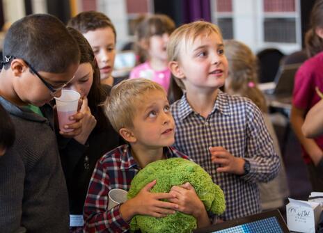 Students stunned looking at a science demonstration