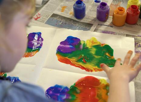 Girl painting using her hands