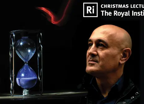 Jim Al-Khalili in front of a dark background with an hourglass