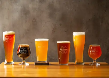 a row of beers in different shapes and sizes.