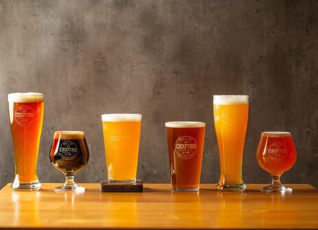 a row of beers in different shapes and sizes.