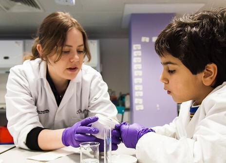 One of staff engaging with a child in the lab