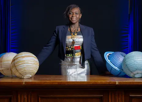 Image of Dame Maggie Aderin-Pocock in the Ri theatre with planets