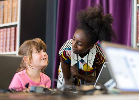 A woman is teaching a child science