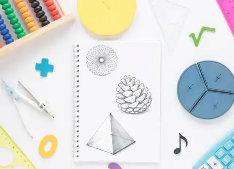Mathematical objects and symbols surrounding a notebook with drawings on