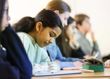 Participants sat at a desk in a workshop