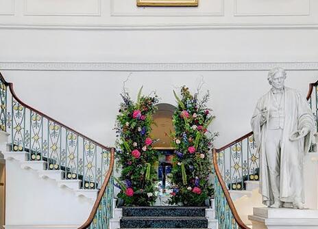 An image of the Ri grand staircase with Michael Faraday statue