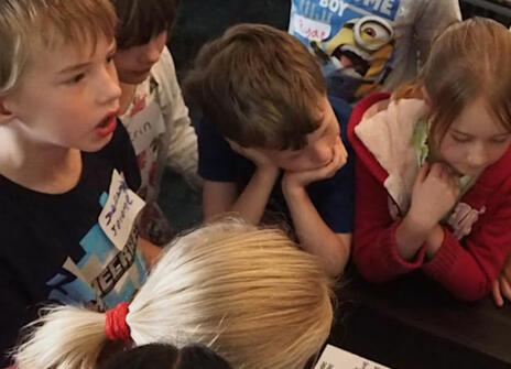 Young children overlooking a table