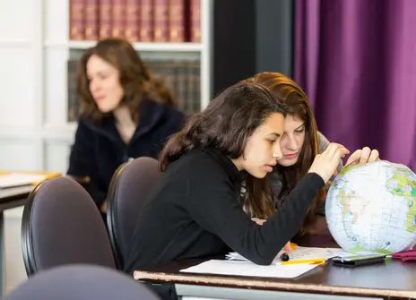 Two participants looking at a globe