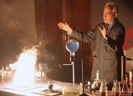 Andrew Szydlo with a desk full of exciting flames
