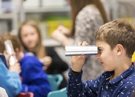 Participant looks through telescope made of foil