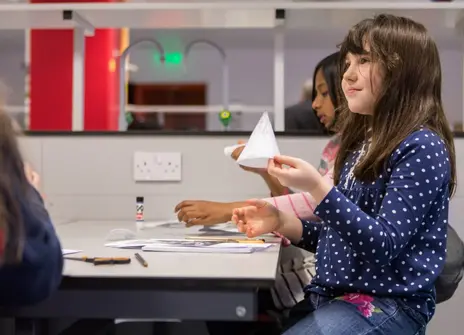 A child holding a paper cone