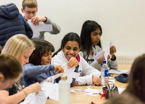 children are cutting paper with scissors