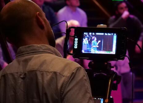 A man filming an event