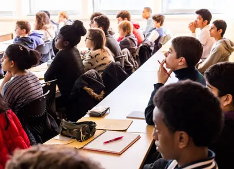 A group of participants sat at desks taking part in a workshop