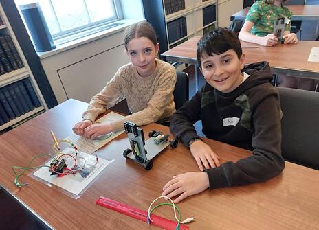 Two children participating in the electronic and electrical control workshop