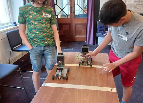 Two children participating the Electronic and Electric Control workshop