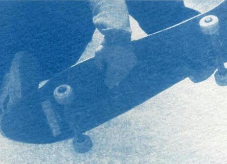 someone holding on to a skateboard with their hands and feet