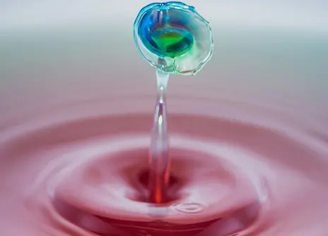 A droplet of water rippling from the surface 