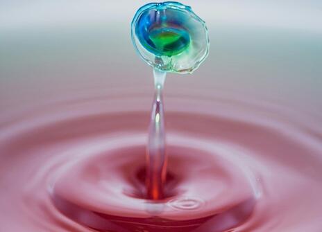 A droplet of water rippling from the surface 