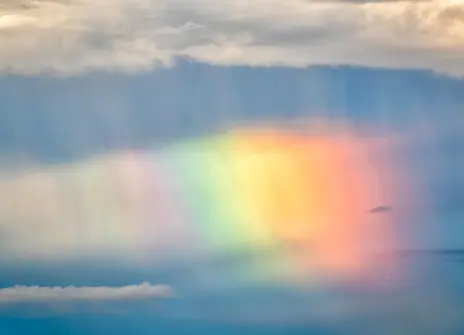 Rainbow in between the clouds