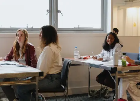 Participants sat at a desk in a workshop