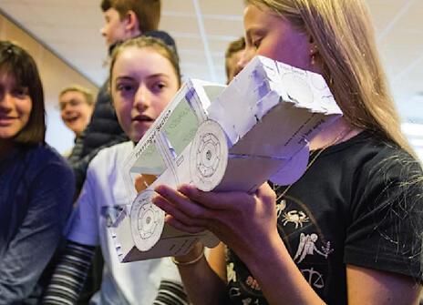 Children holding paper car
