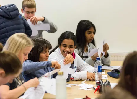 Participants sat at a desk in a workshop
